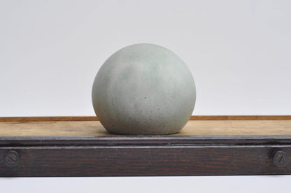 Light grey and green cement sphere decor