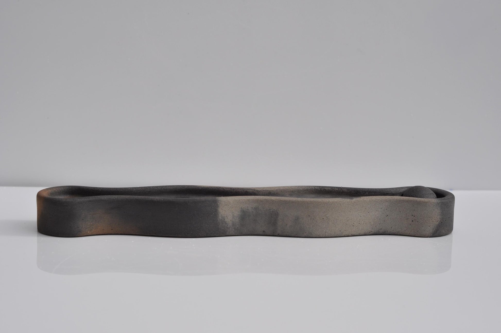 Studio photo of handmade modern concrete incense tray