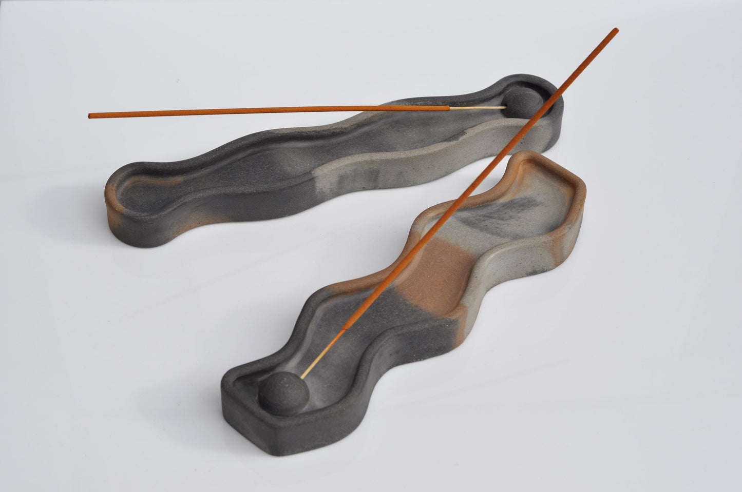 Concrete incense holder paired with small candle