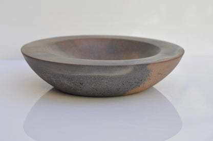 Studio shot of handmade grey and orange concrete bowl