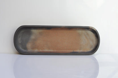 Side view of handmade long oval concrete dish