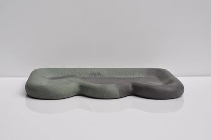 Studio shot of handmade dark grey-green concrete tray