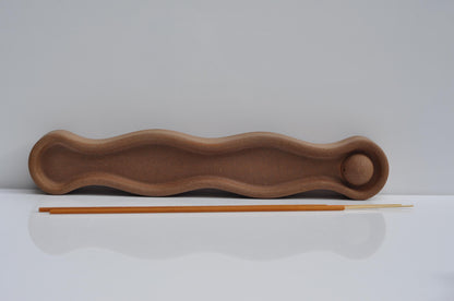 Cement incense holder with a stick on a white background