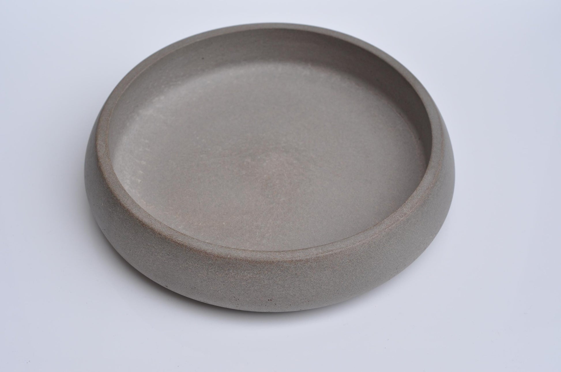 Concrete bowl with fruits and décor on table