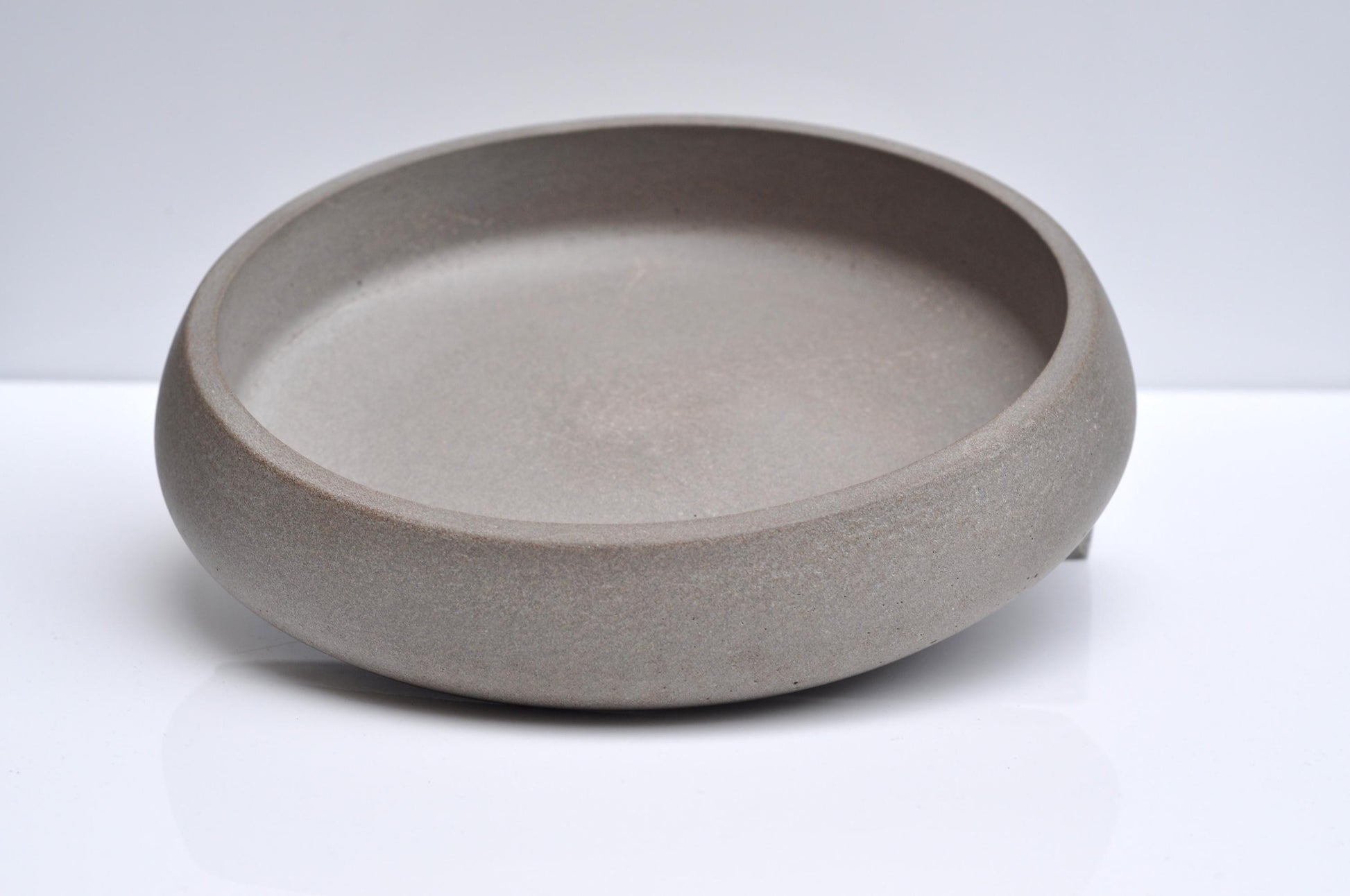 Studio shot of large handmade concrete fruit bowl