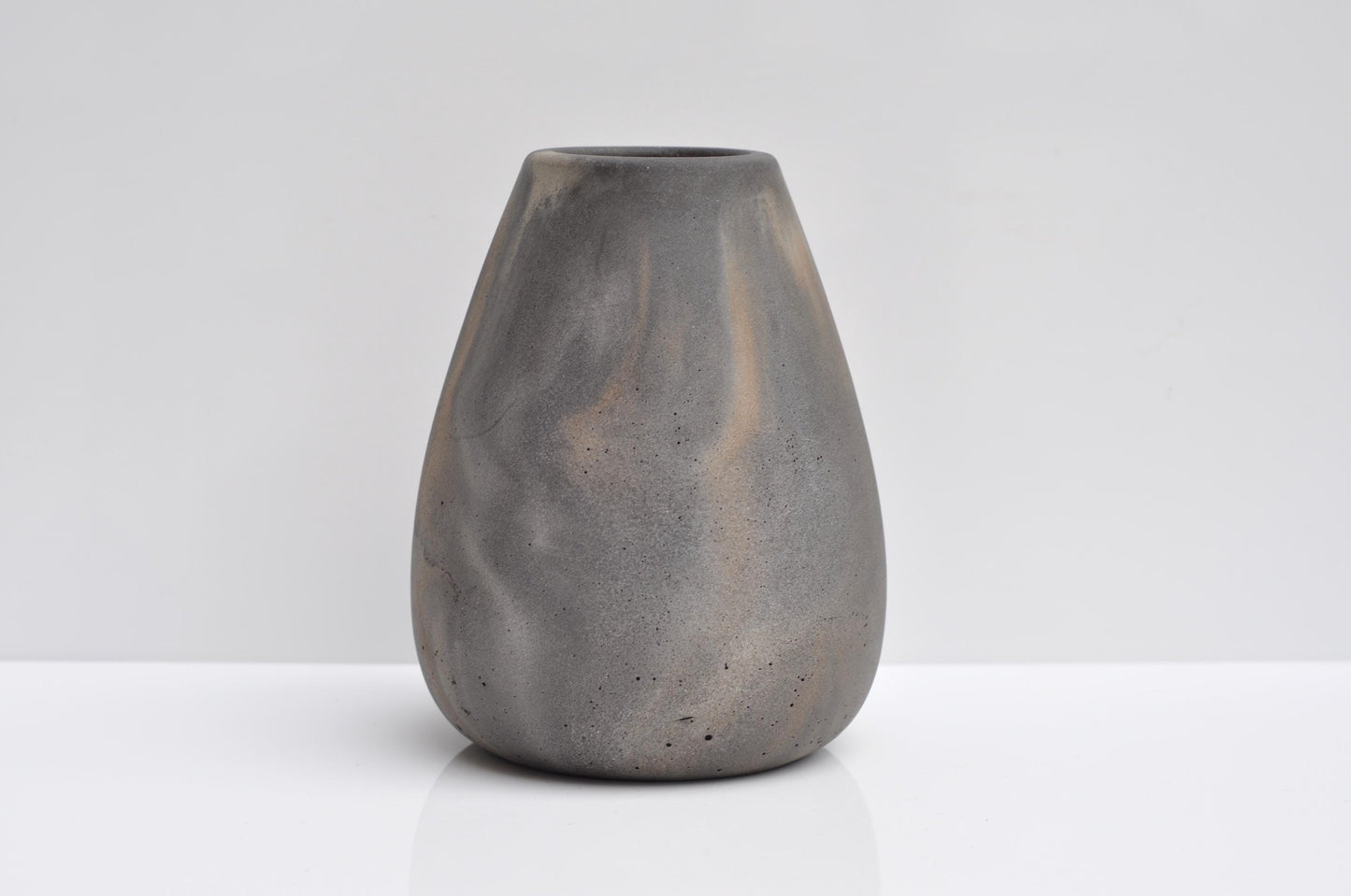 Studio shot of handmade grey and orange concrete vase