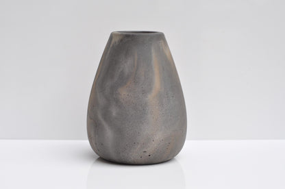 Studio shot of handmade grey and orange concrete vase