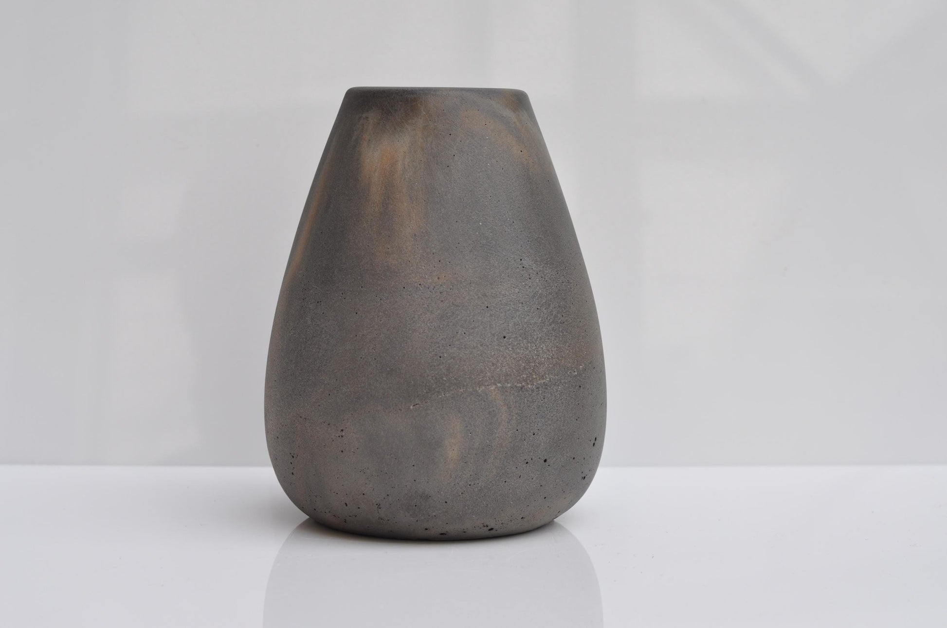 Dark gray concrete vase on a white background