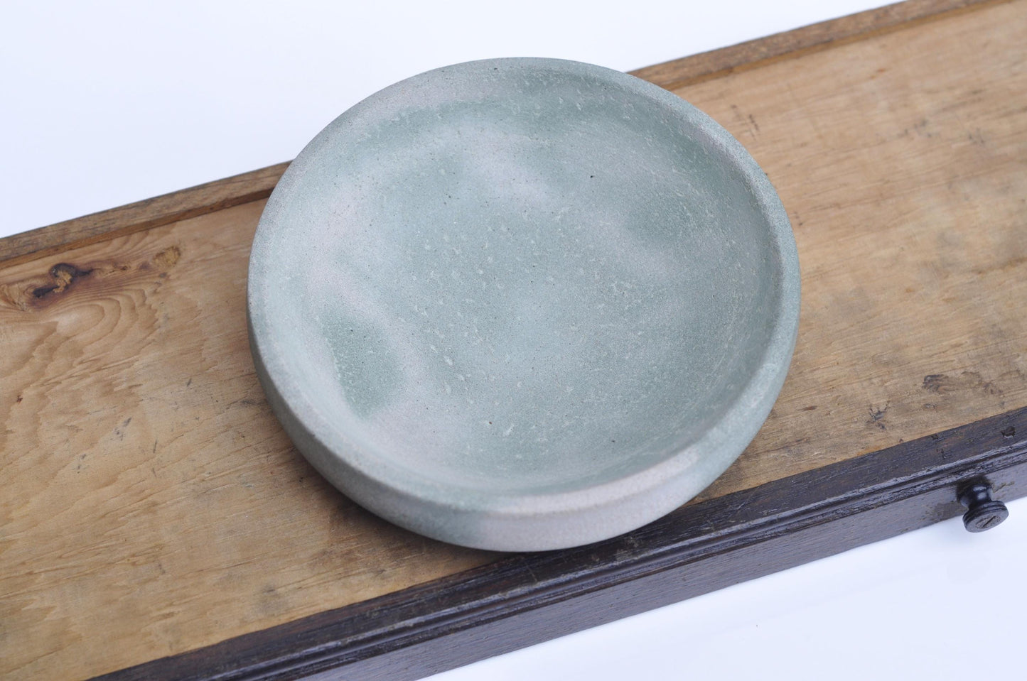 Rustic concrete bowl with green accent