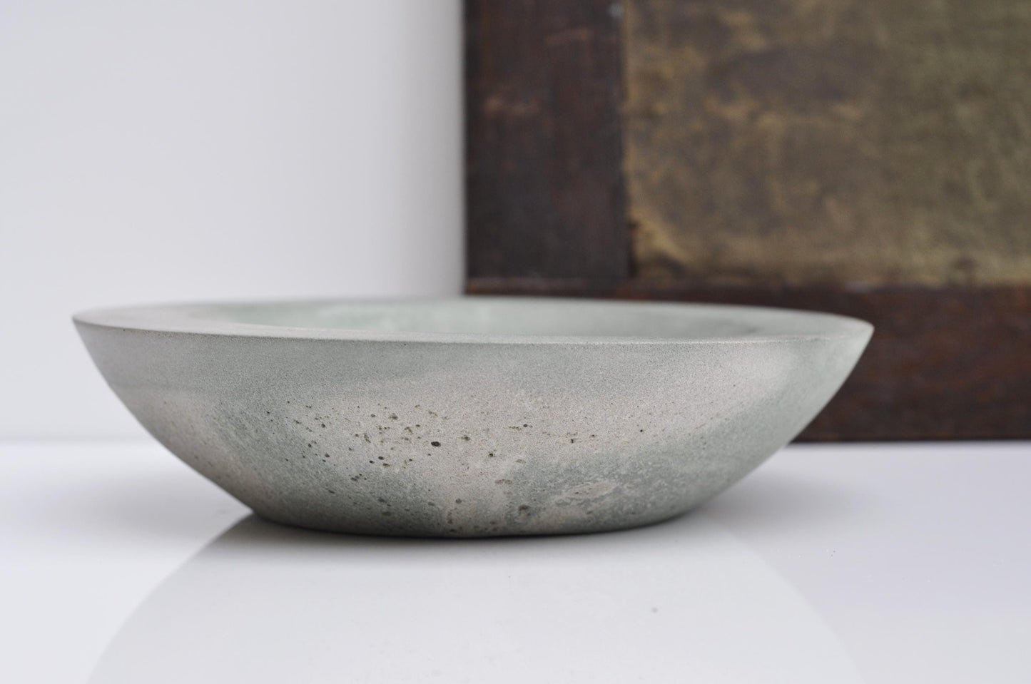 Minimalist green-grey concrete dish on tabletop