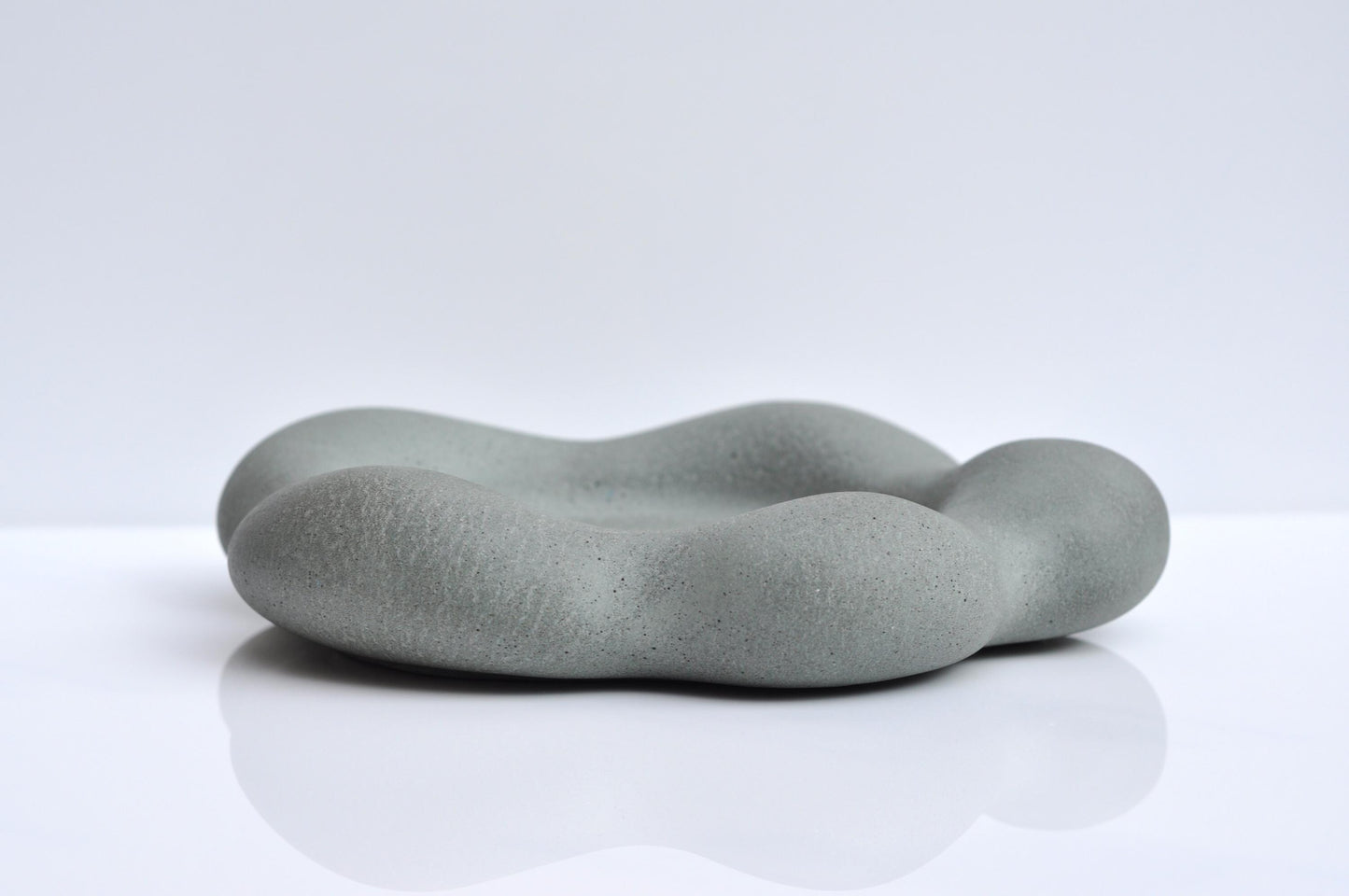 Heavy grey concrete plate with organic flower form