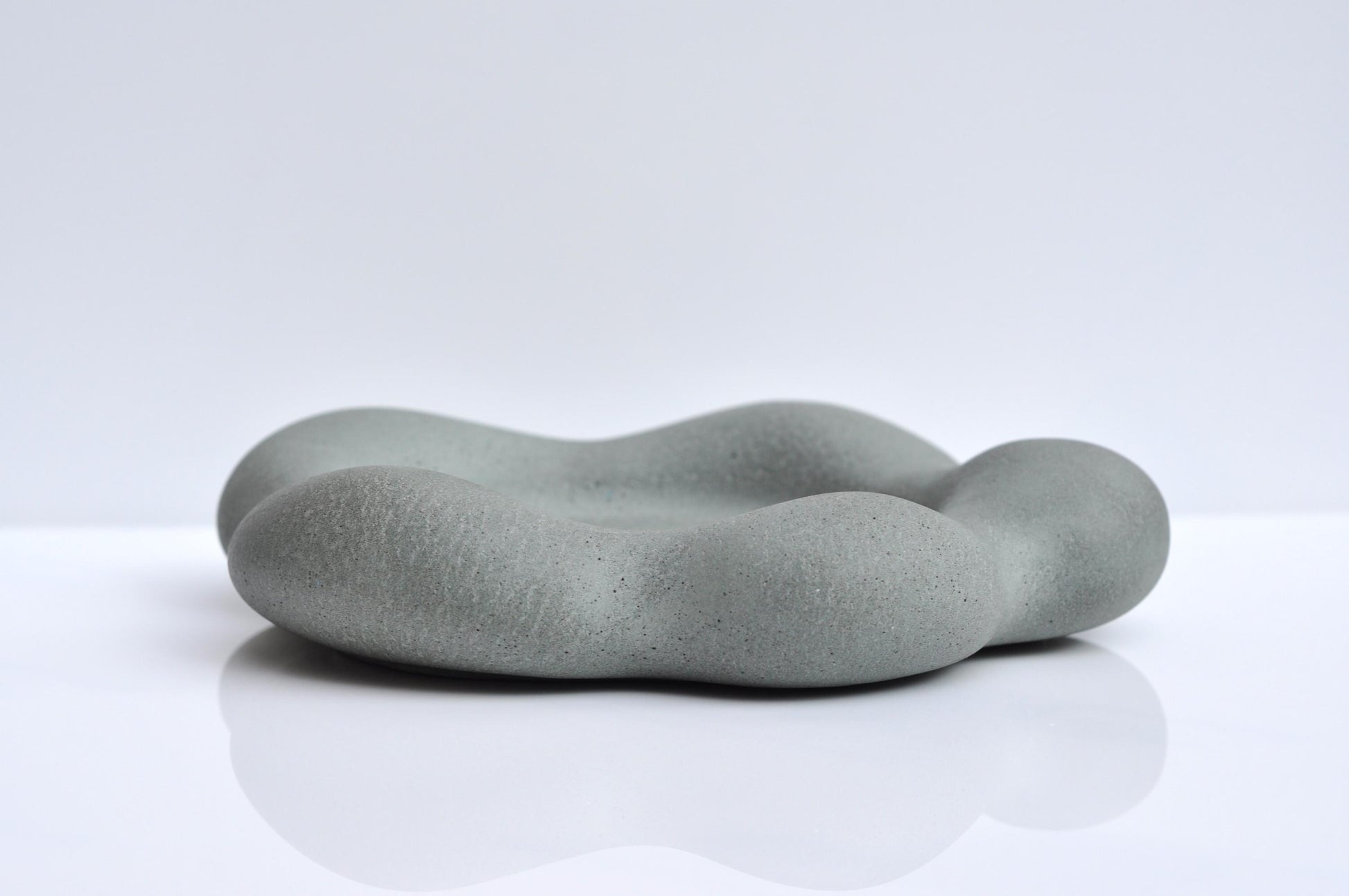 Heavy grey concrete plate with organic flower form