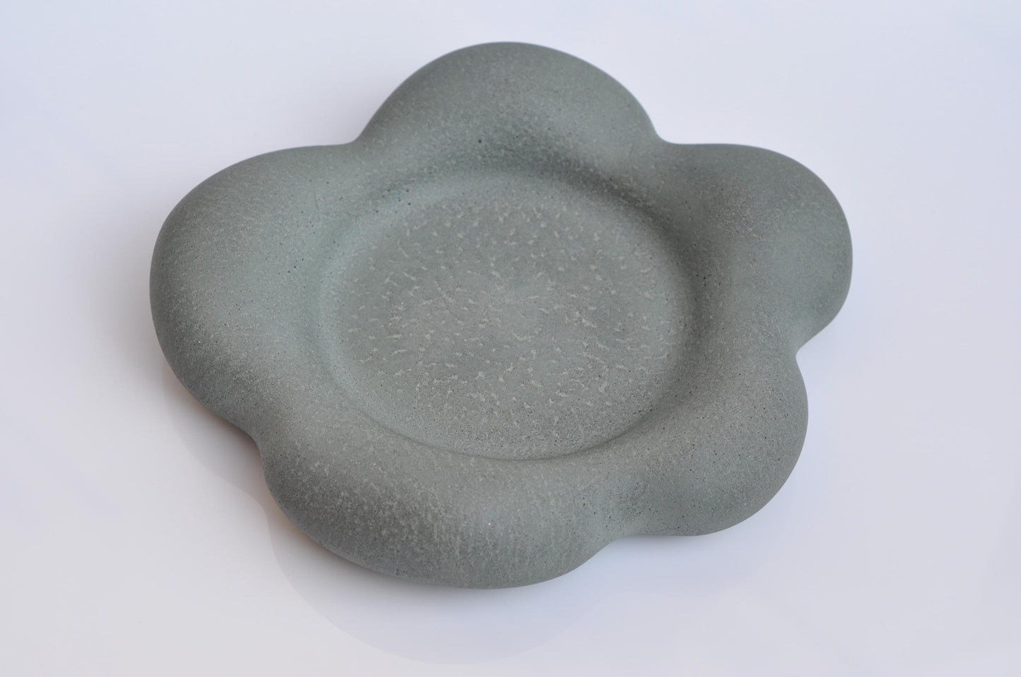 Heavy grey concrete plate with organic flower form