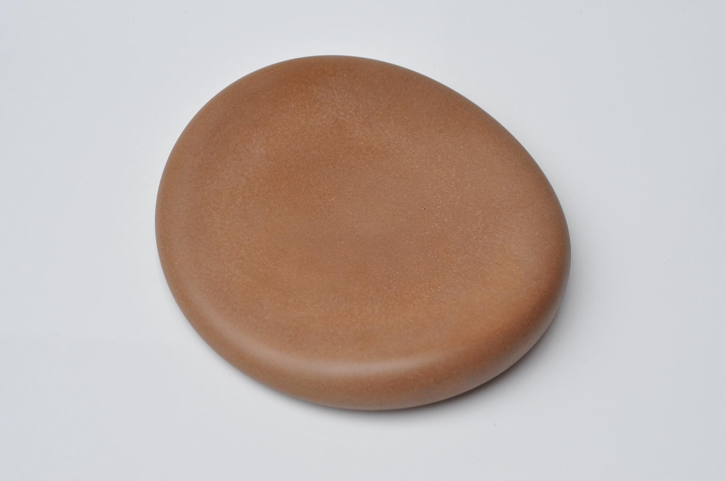 Pebble-shaped handmade orange concrete decor piece