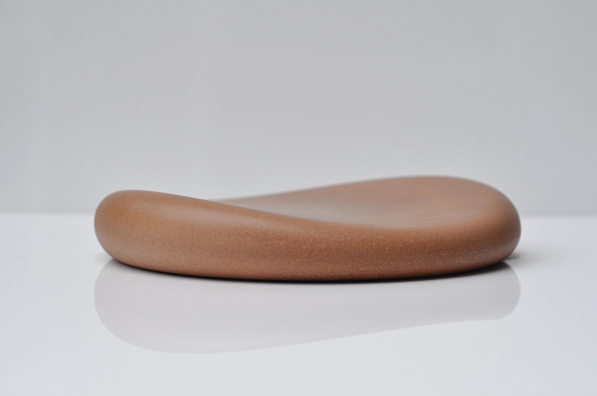 Minimalist organic-shaped concrete tray