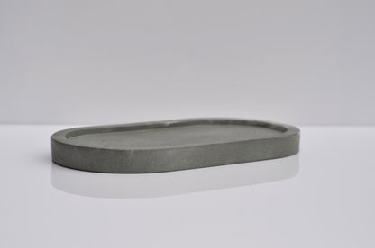 Gray stone tray on a white surface with a light gray background