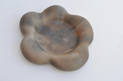 Handmade concrete tray used as a decorative candle plate