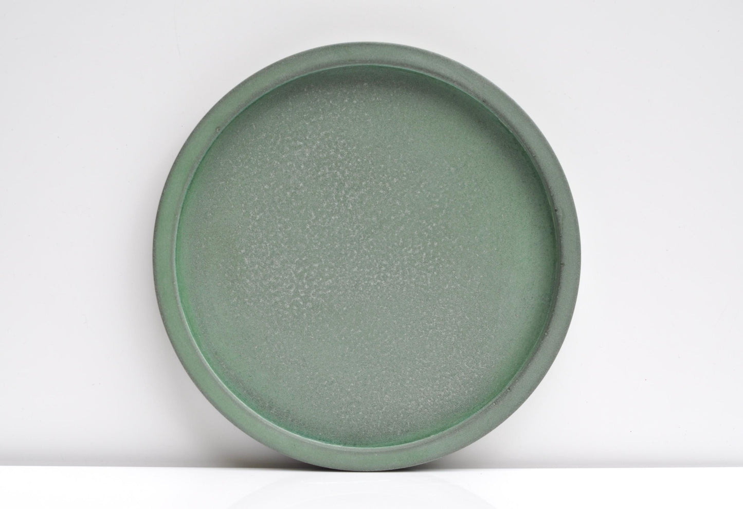 Studio shot of handmade green concrete tray