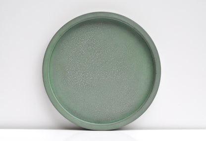 Studio shot of handmade green concrete tray