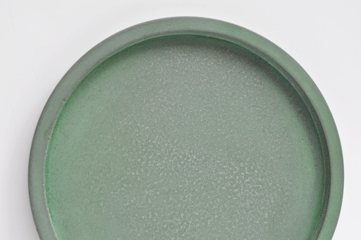 Green concrete tray for keys or jewellery on desk