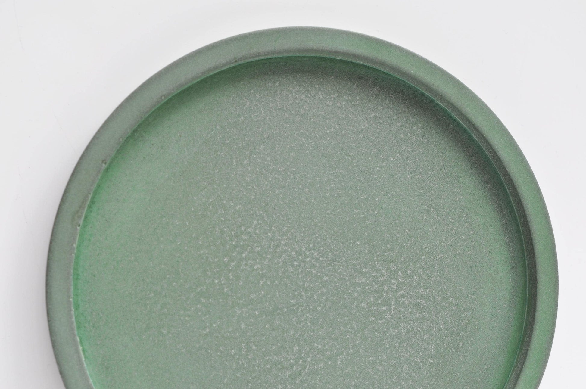 Green concrete tray for keys or jewellery on desk