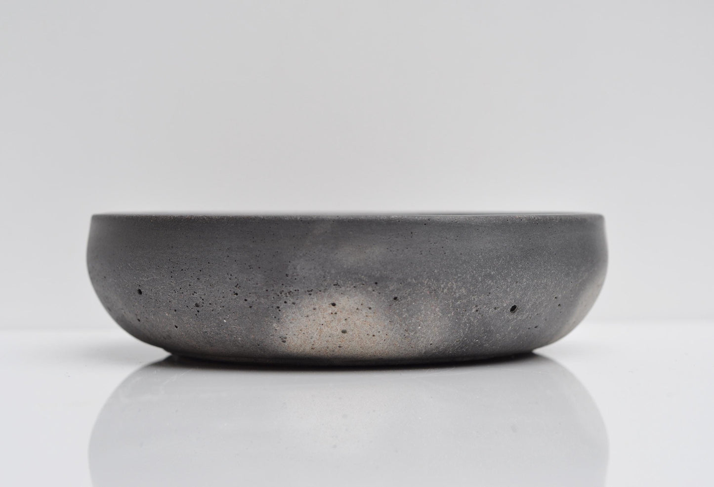Studio shot of small handmade grey concrete bowl