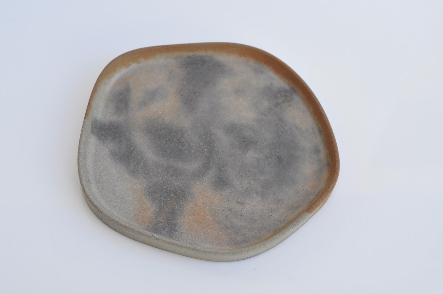 Irregular shaped tray used for candles and accessories