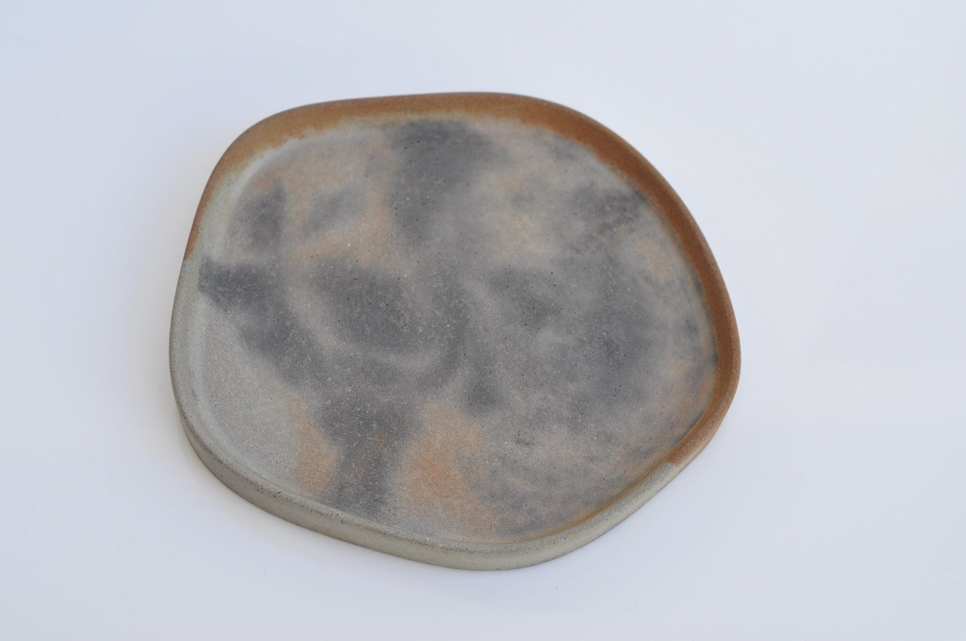 Irregular shaped tray used for candles and accessories