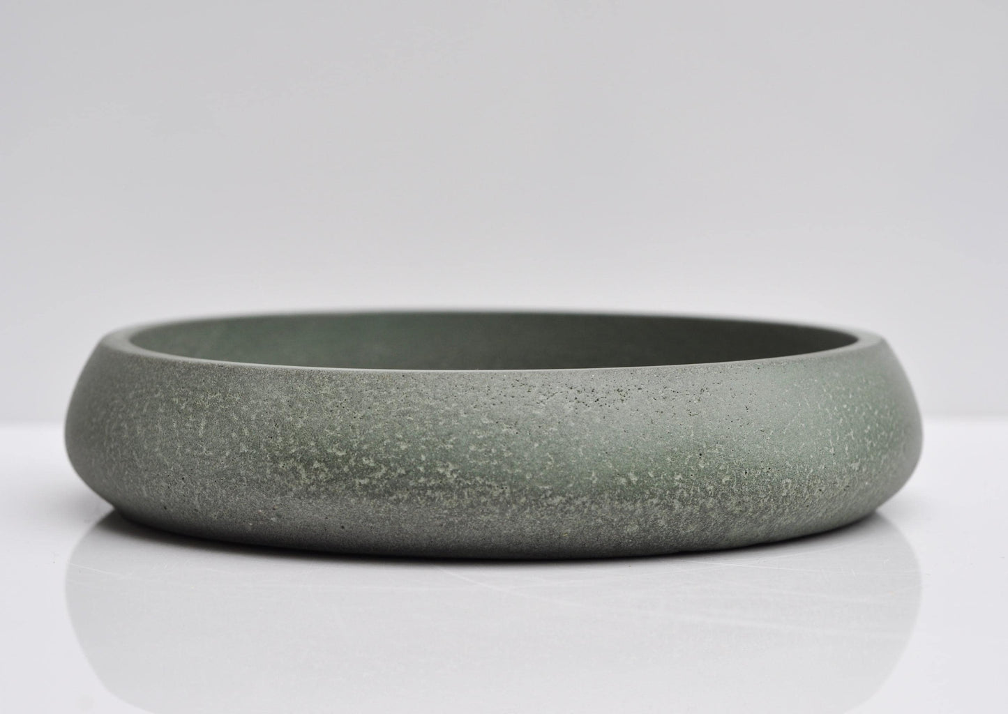 Studio shot of handmade green concrete bowl