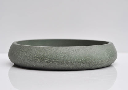 Studio shot of handmade green concrete bowl