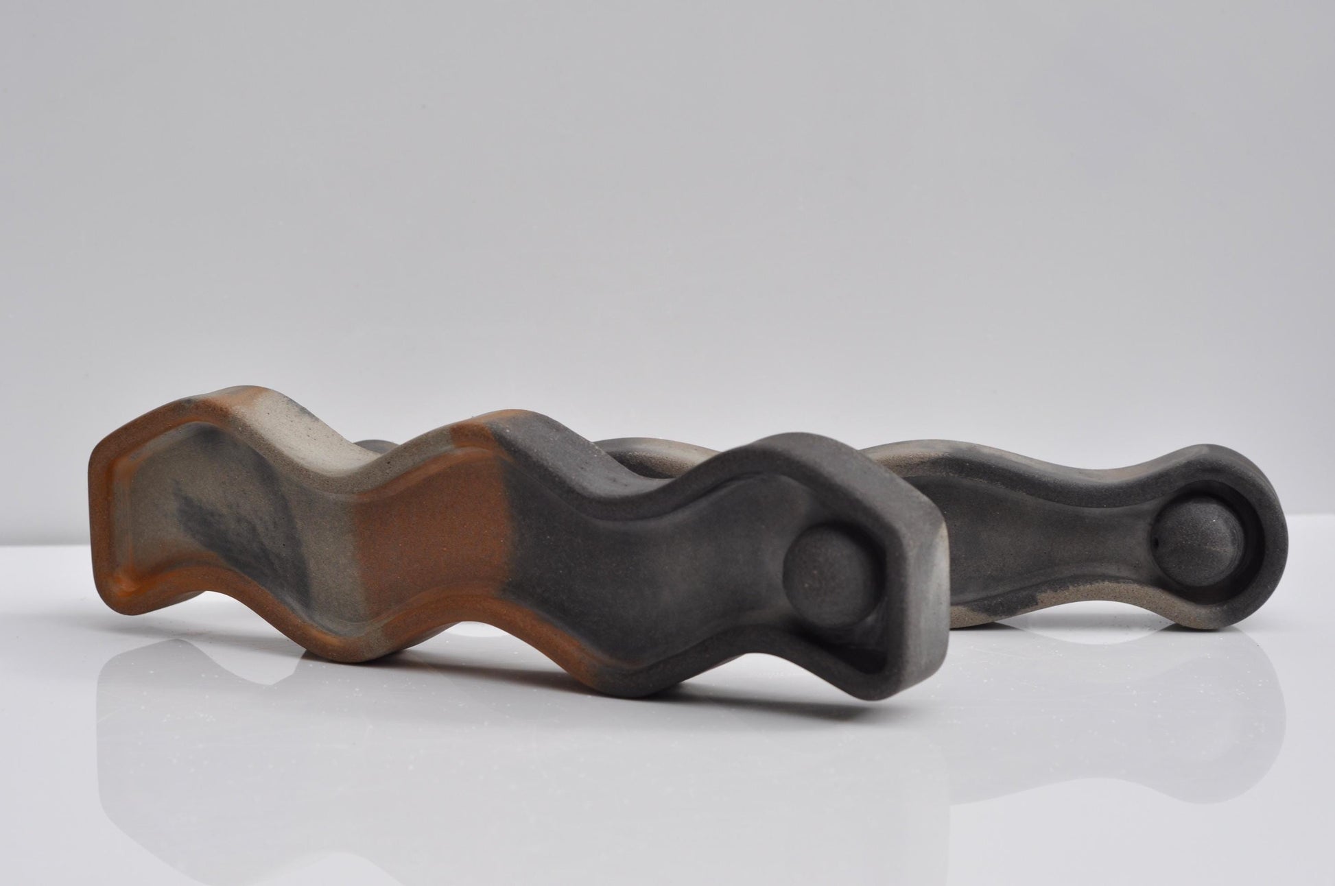 Decorative wavy concrete incense burner on shelf